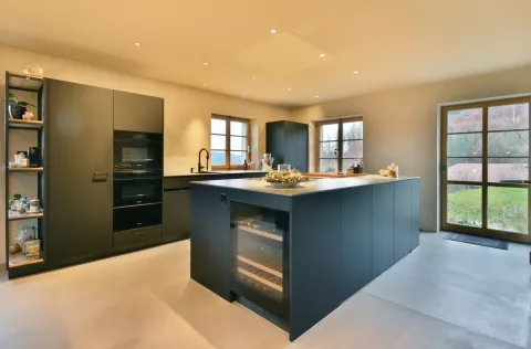 Moderne schwarze Küche mit integriertem Weinkühlschrank und LED-Spots in der Decke